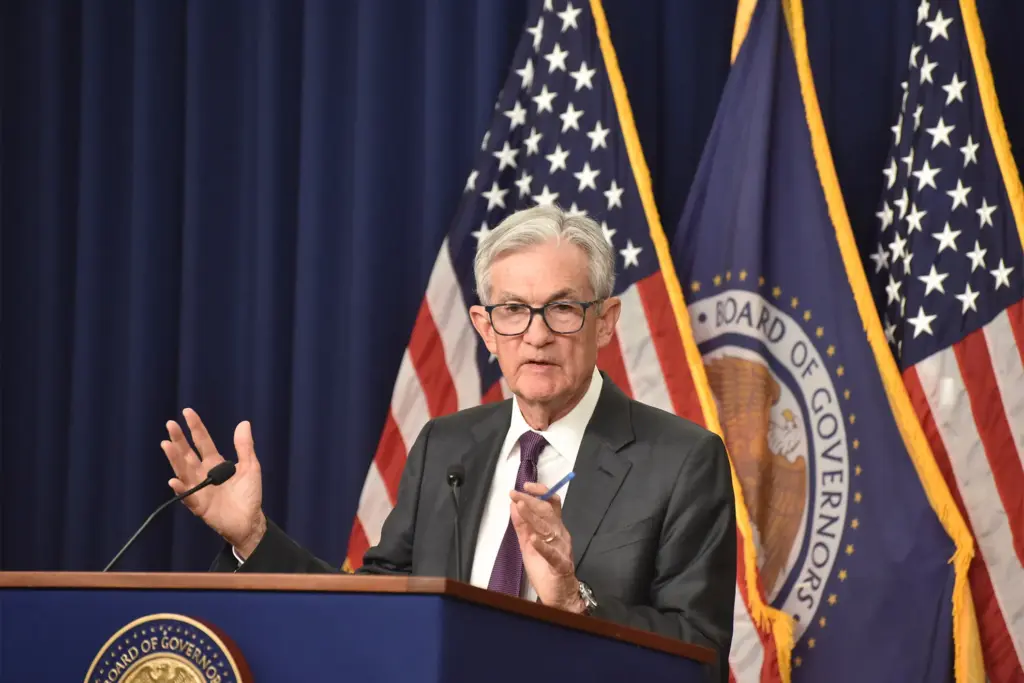 Jerome Powell delivering FOMC rate-cut announcement at press podium